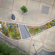 Aerial view of an urban SuDS rain garden surrounded by paved public space
